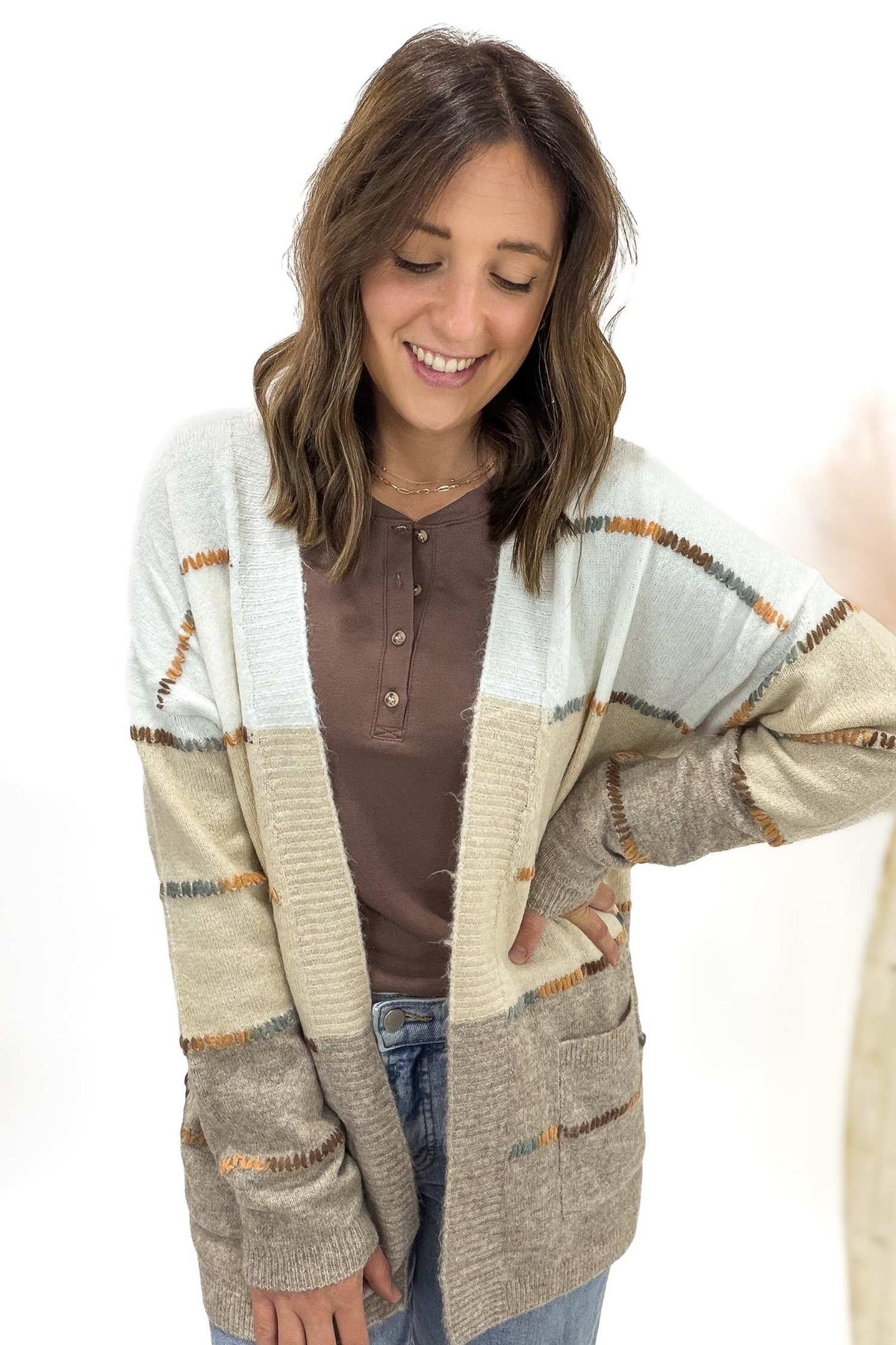 Woman wearing a patterned cardigan on a white background