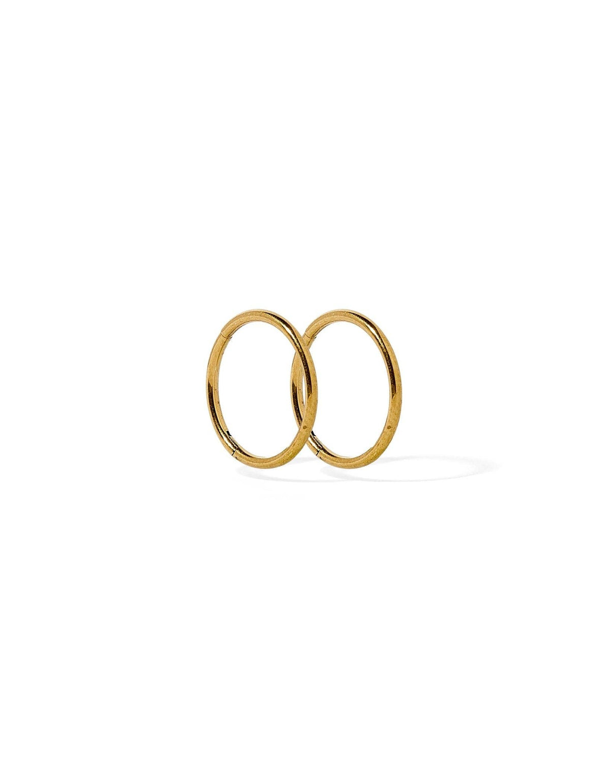 Two gold hoop earrings on a white background