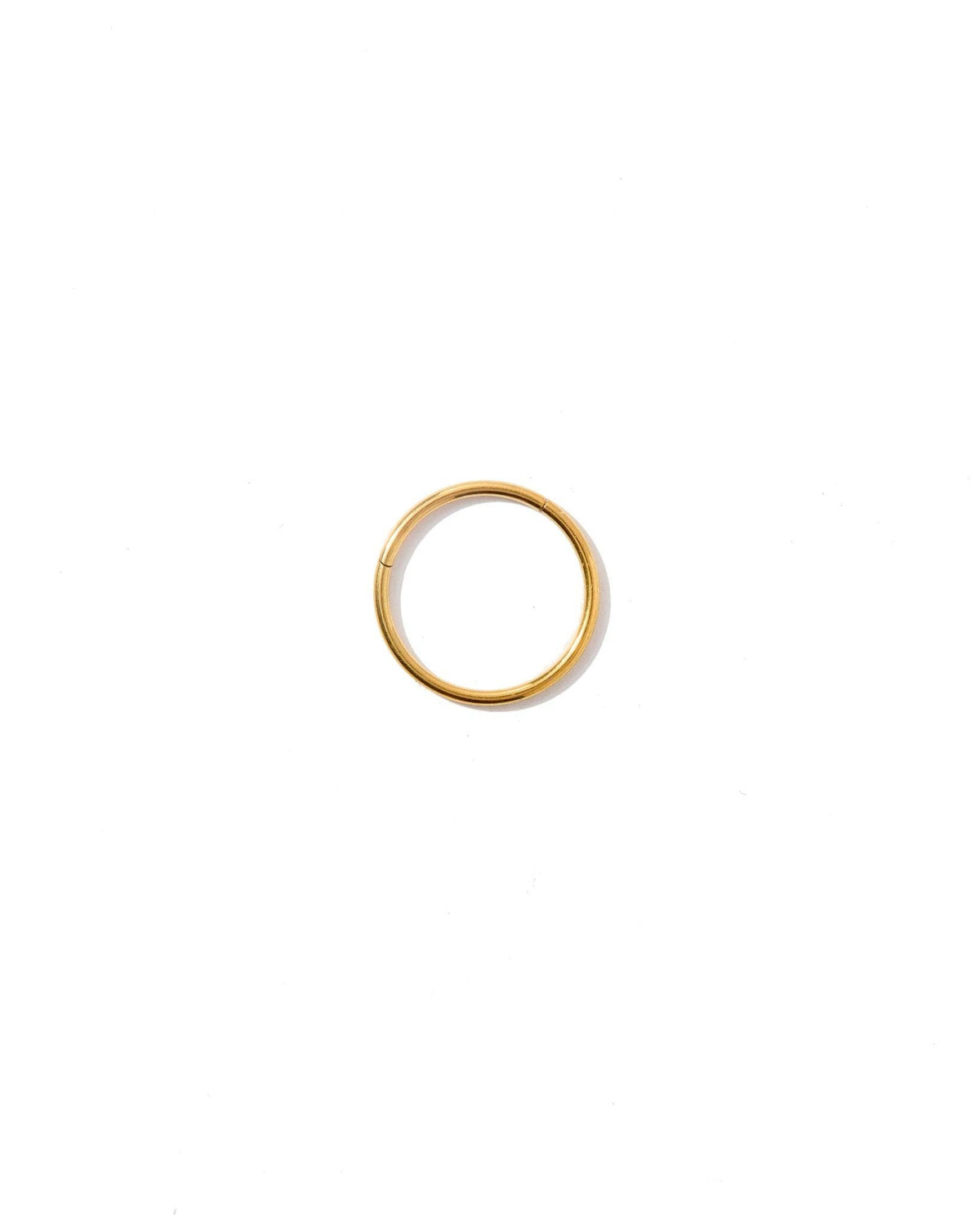 Gold hoop earring on a white background
