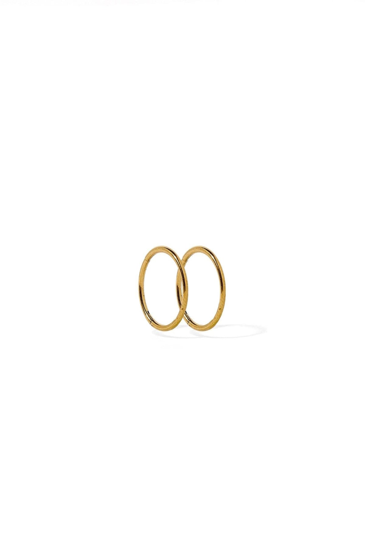 Two gold rings stacked on a white background