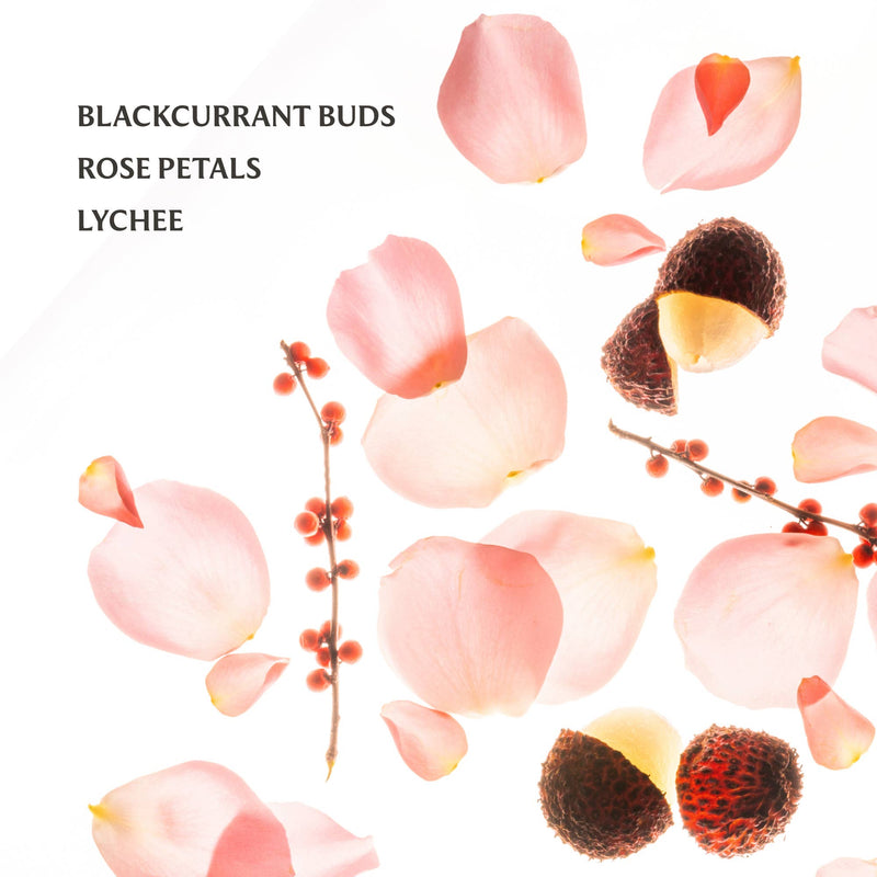 Blackcurrant buds, rose petals, and lychees on a white background