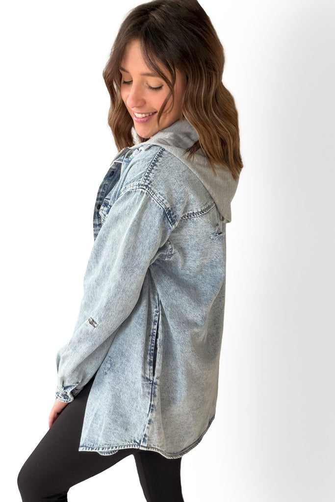 Woman wearing a light blue denim shirt on a white background