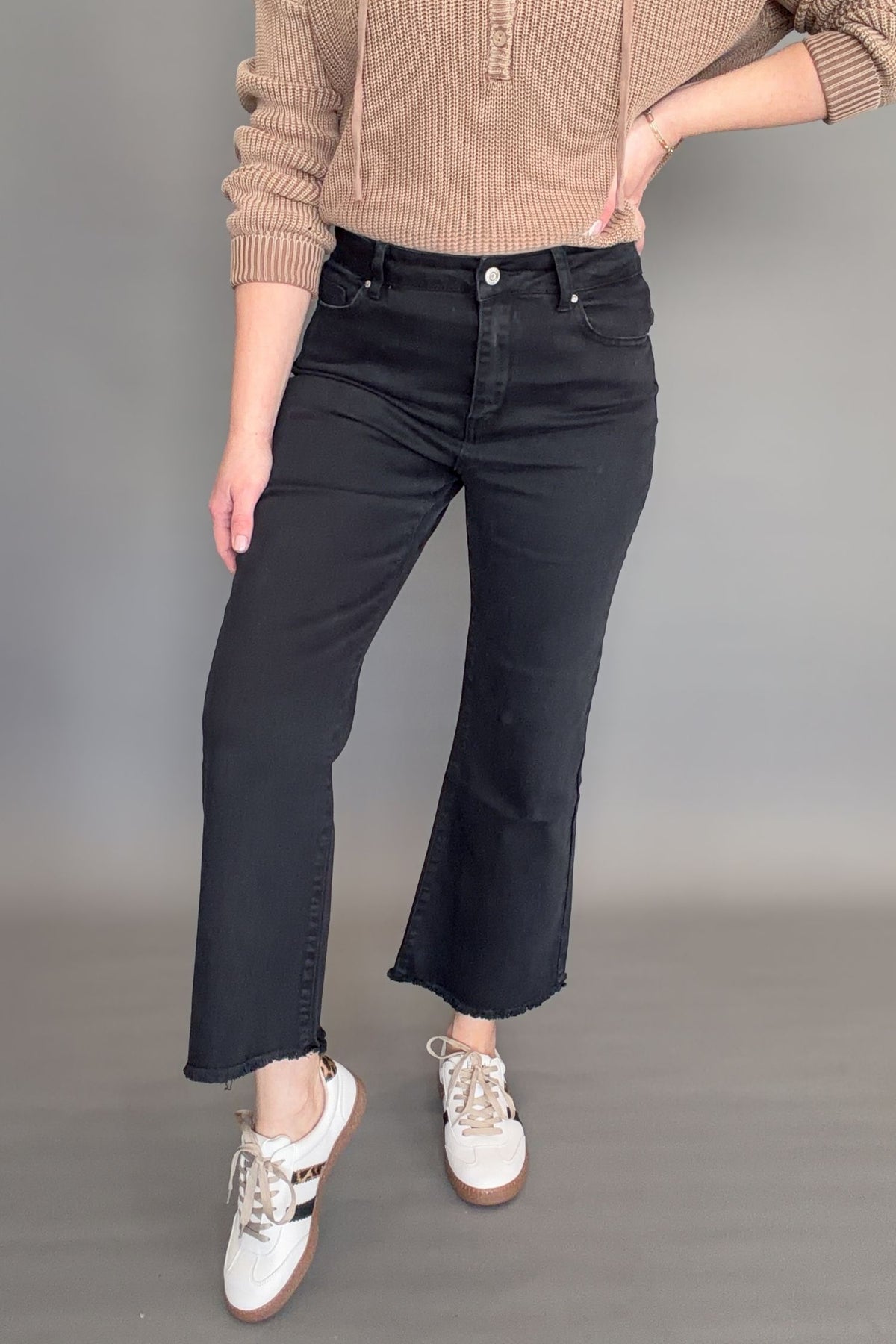 Front view of women’s black high rise crop bootcut jeans with structured stretch and cropped flare silhouette.