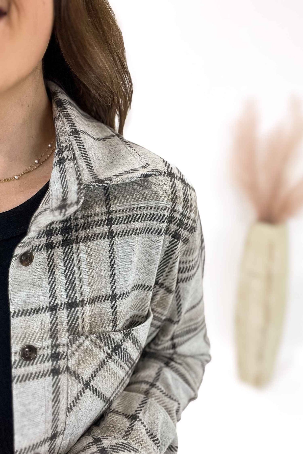 Plaid jacket worn by a person with a blurred background