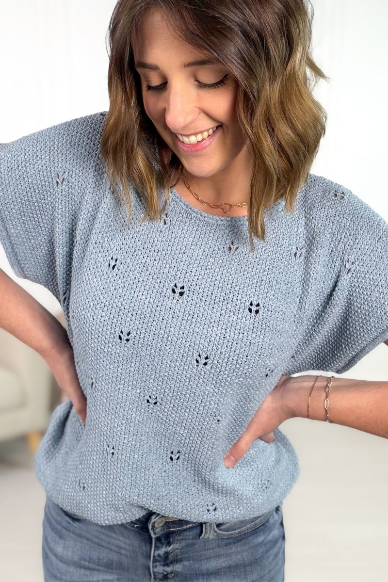 Blue knit short sleeve tee with relaxed fit and textured open knit detail.