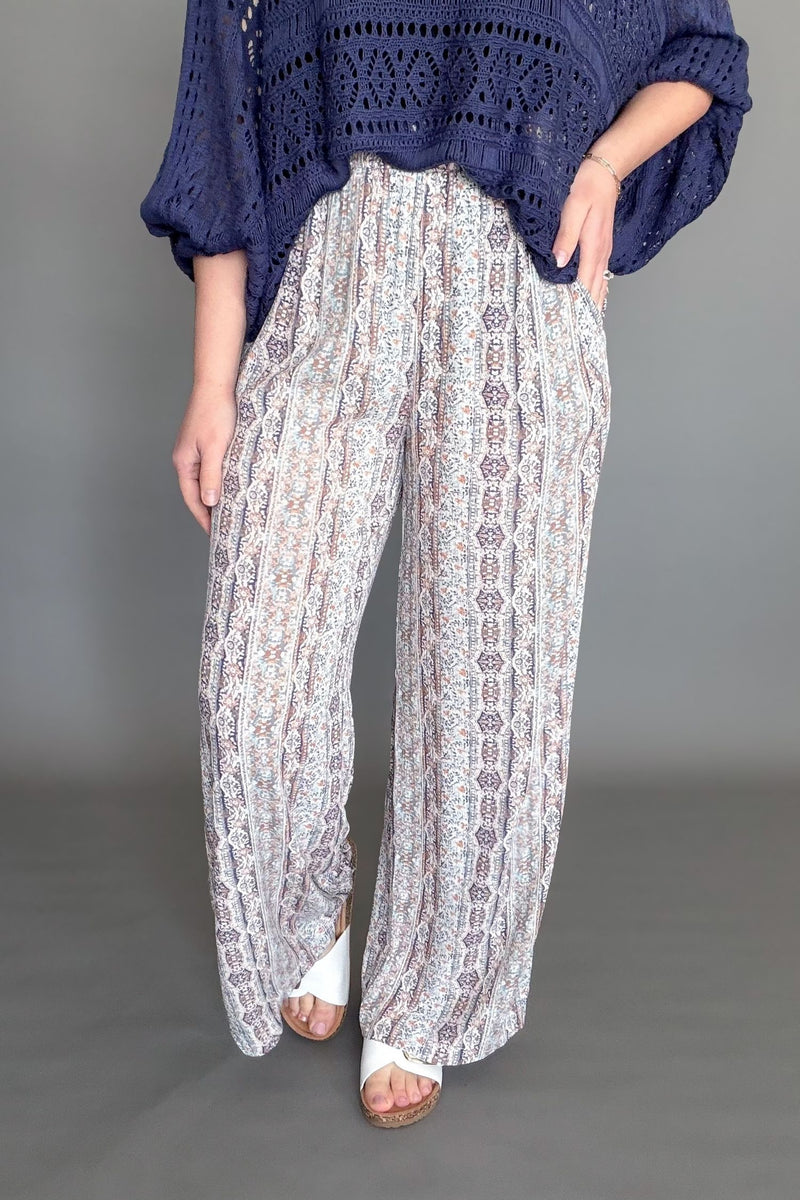 Blue patterned palazzo pants with wide leg flowy fit styled with a knit top