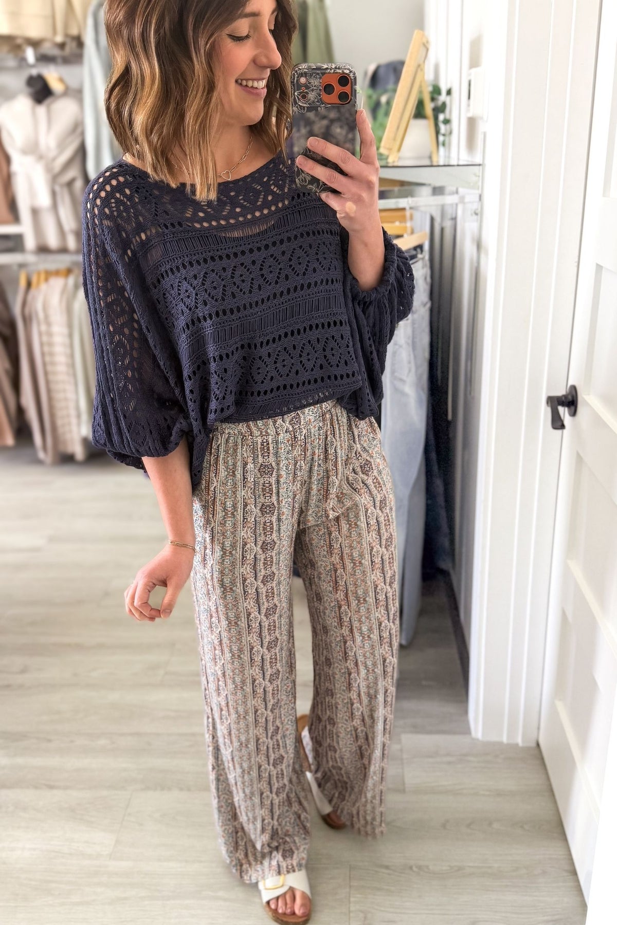 Flowy boutique palazzo pants styled with navy top and white sandals