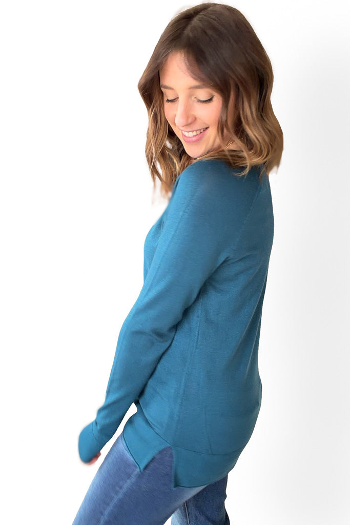 Woman wearing a blue sweater on a white background