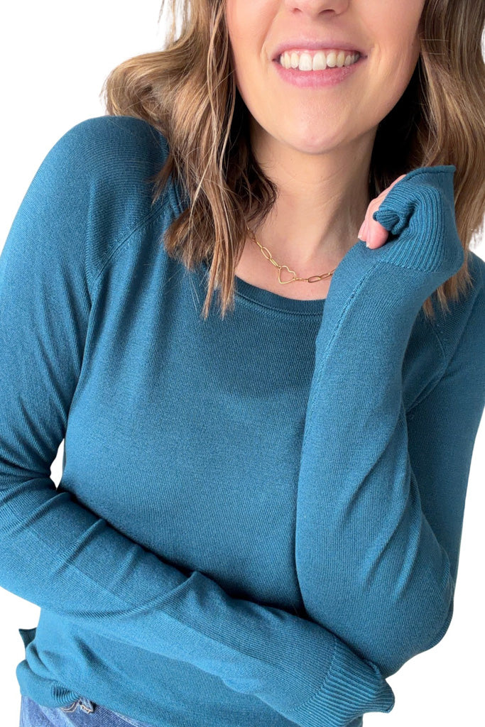 Woman wearing a blue sweater on a white background