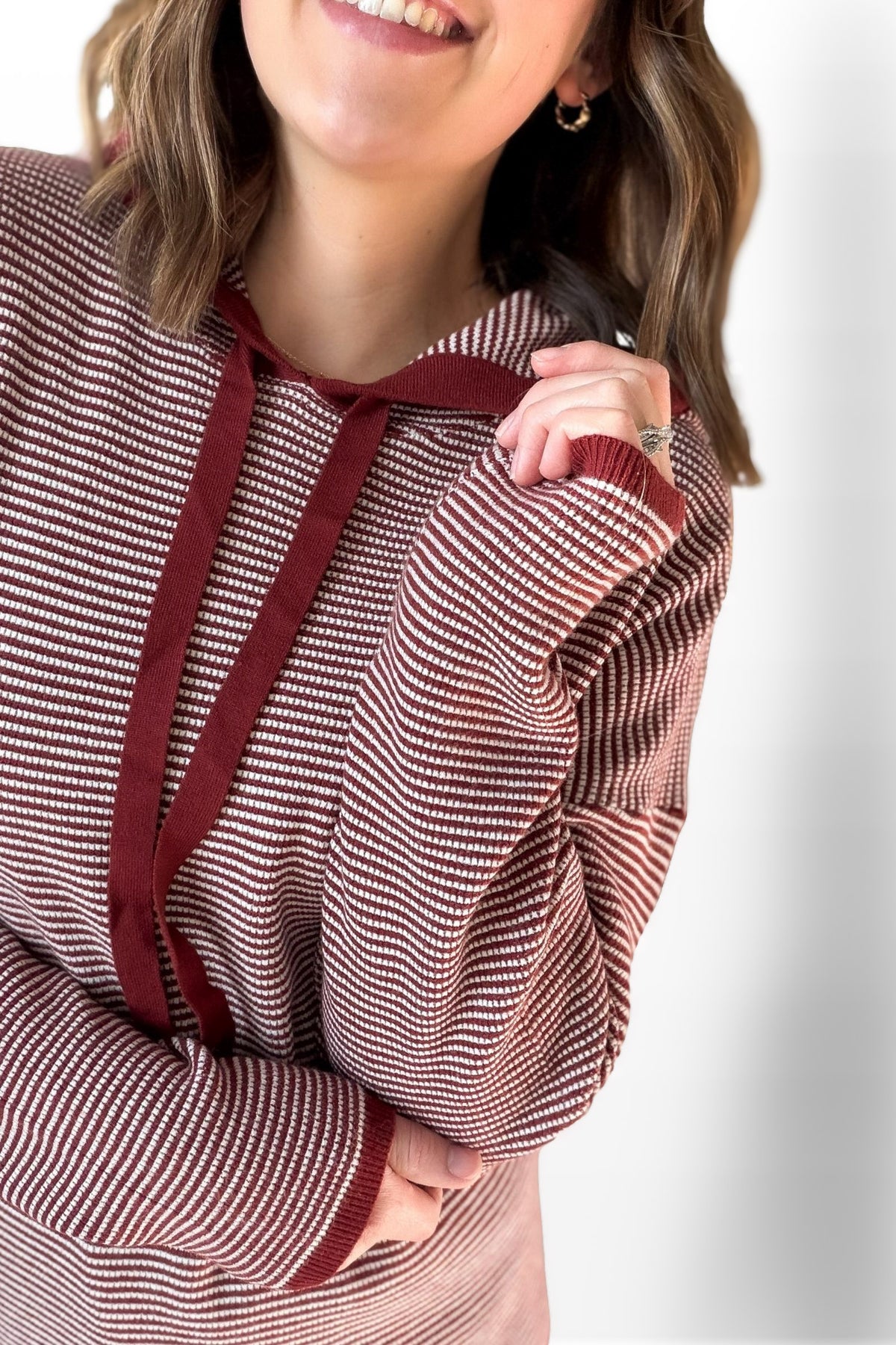 woman wearing a striped waffle hoodie with a white background