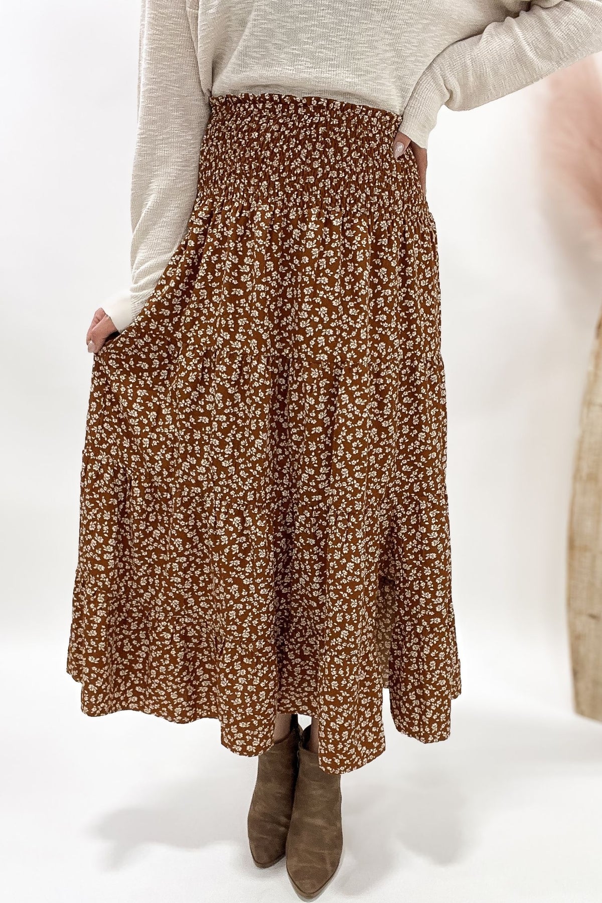 Person wearing a Camel floral skirt on a white background