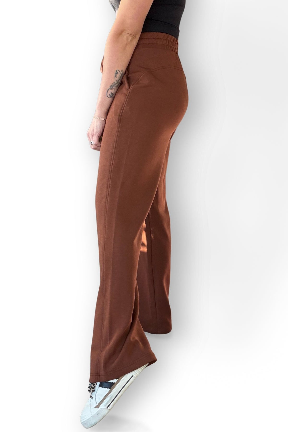 Chestnut scuba strait pants worn by a person on a white background showing side length