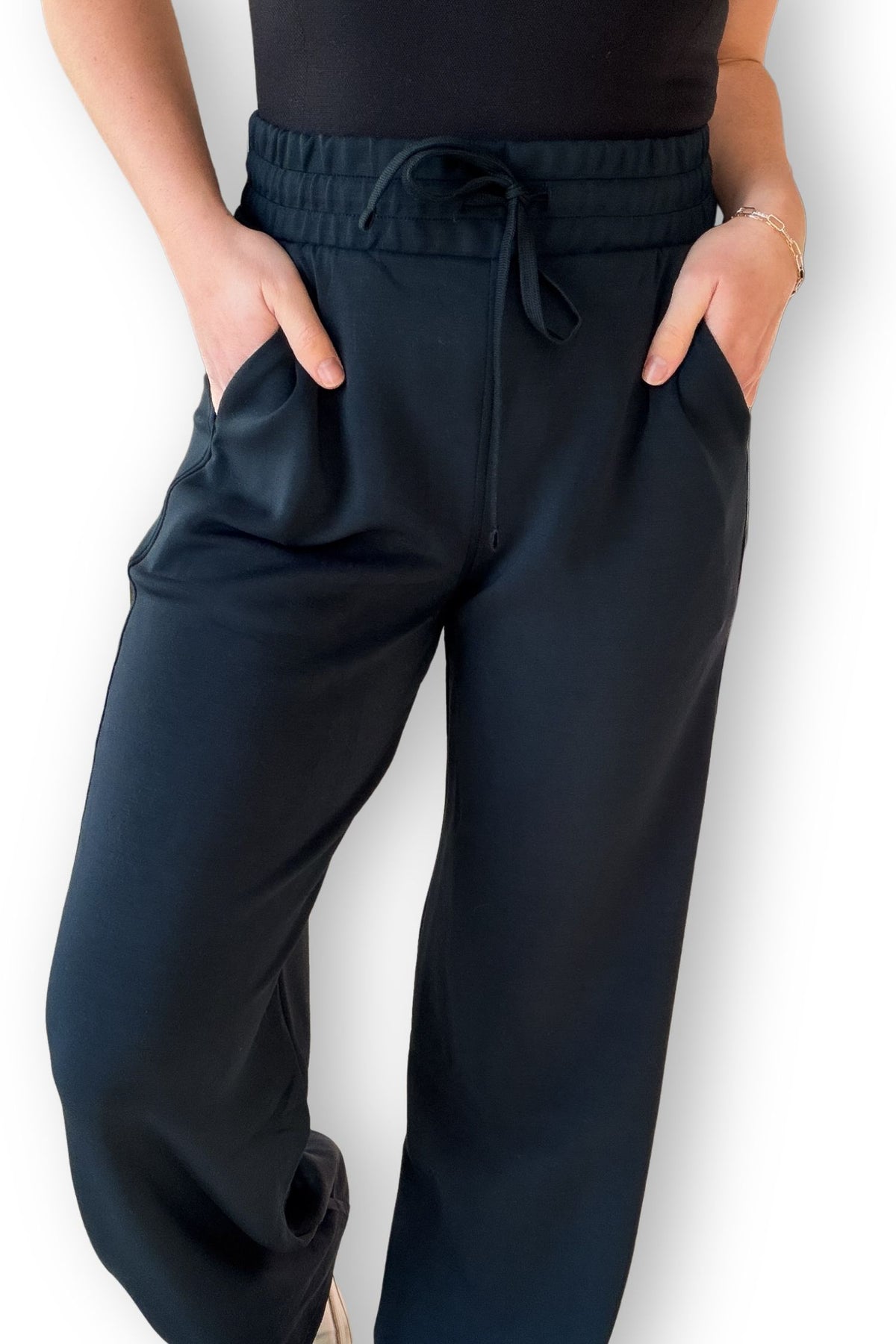 Woman wearing navy scuba material pants with pockets
