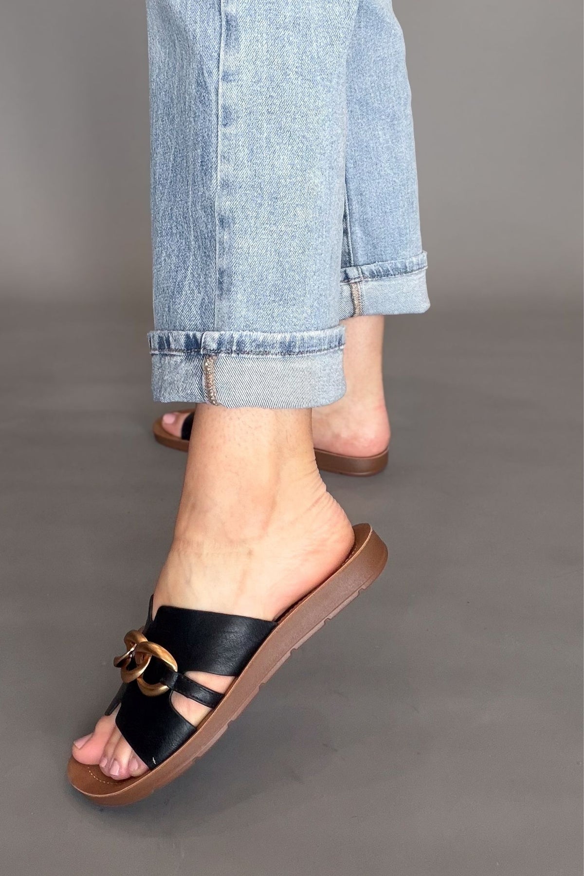 Comfortable black slip on sandals with gold accent
