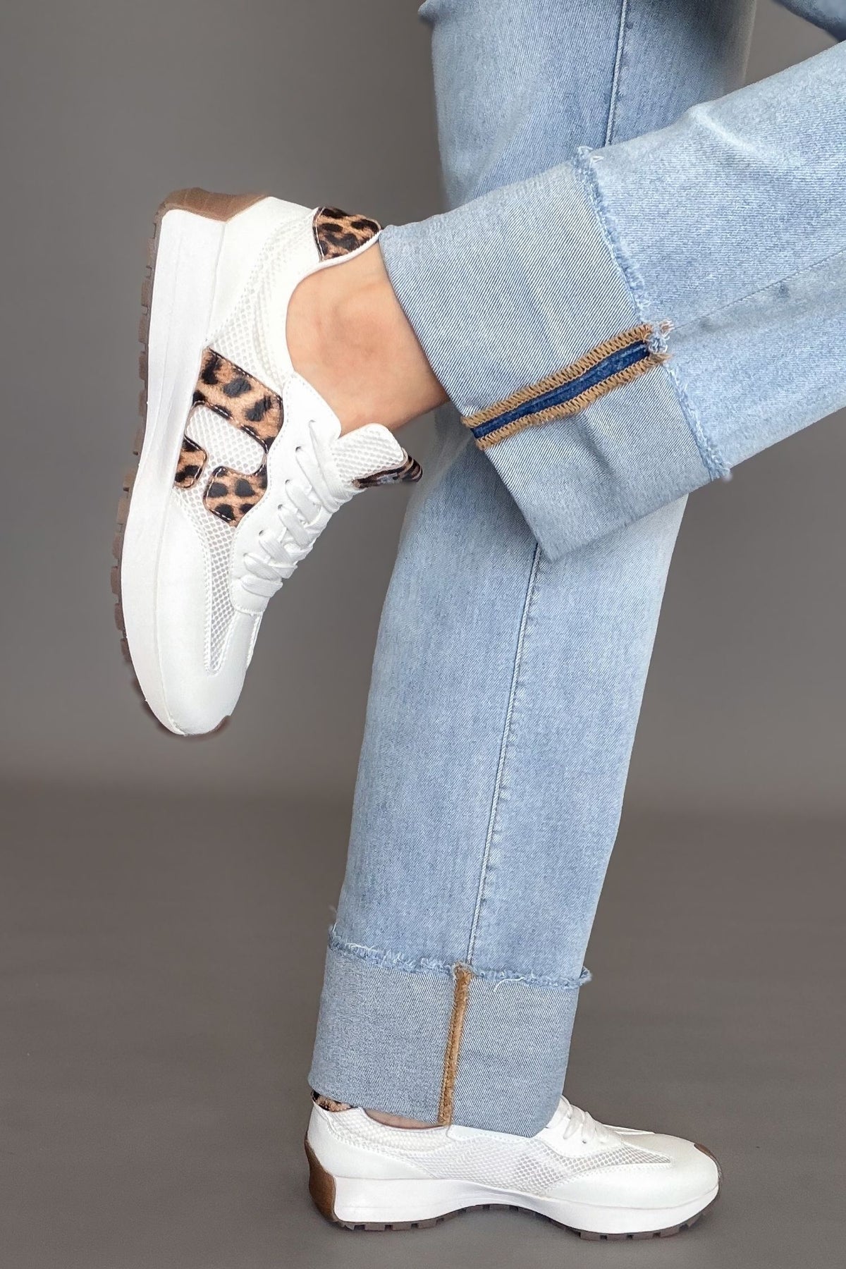 White Corkys No Prob sneakers with leopard print detail styled with light wash denim.