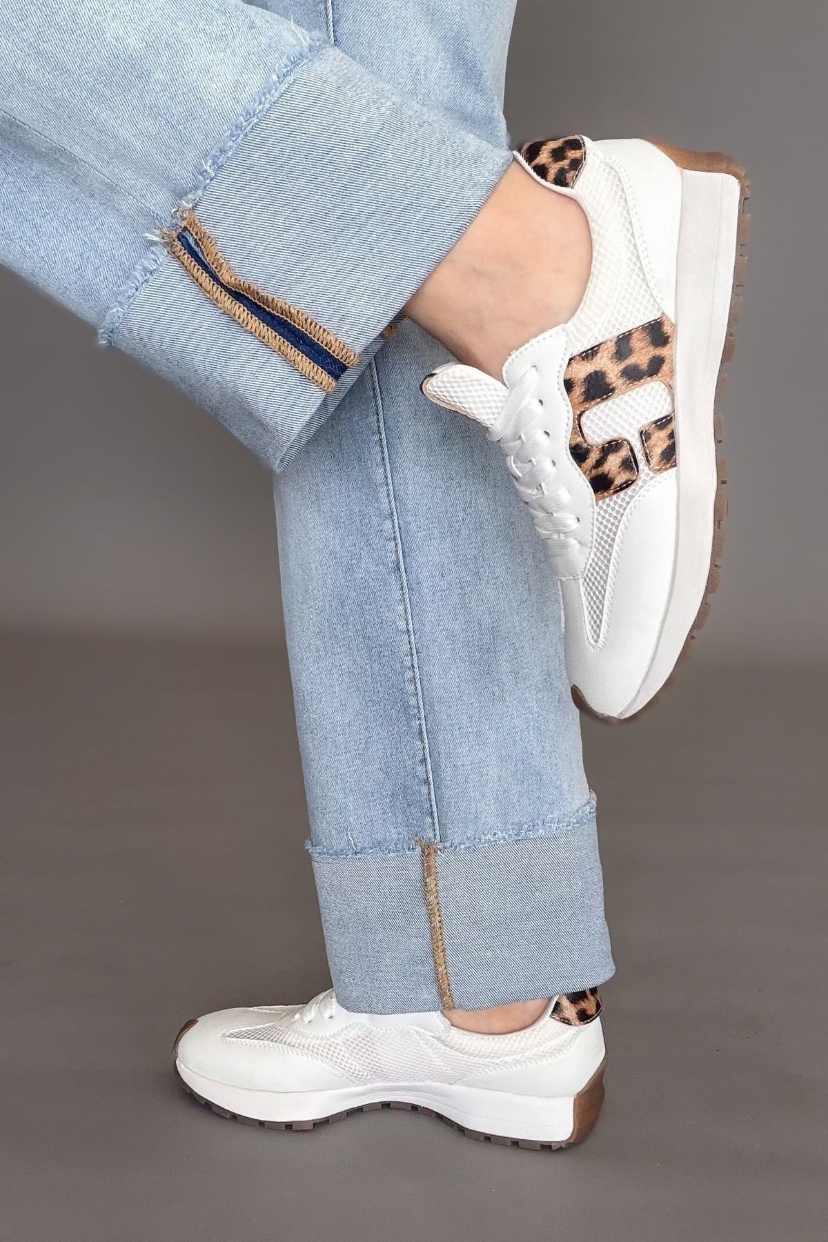 White Corkys No Prob sneakers with leopard print detail styled with light wash denim.