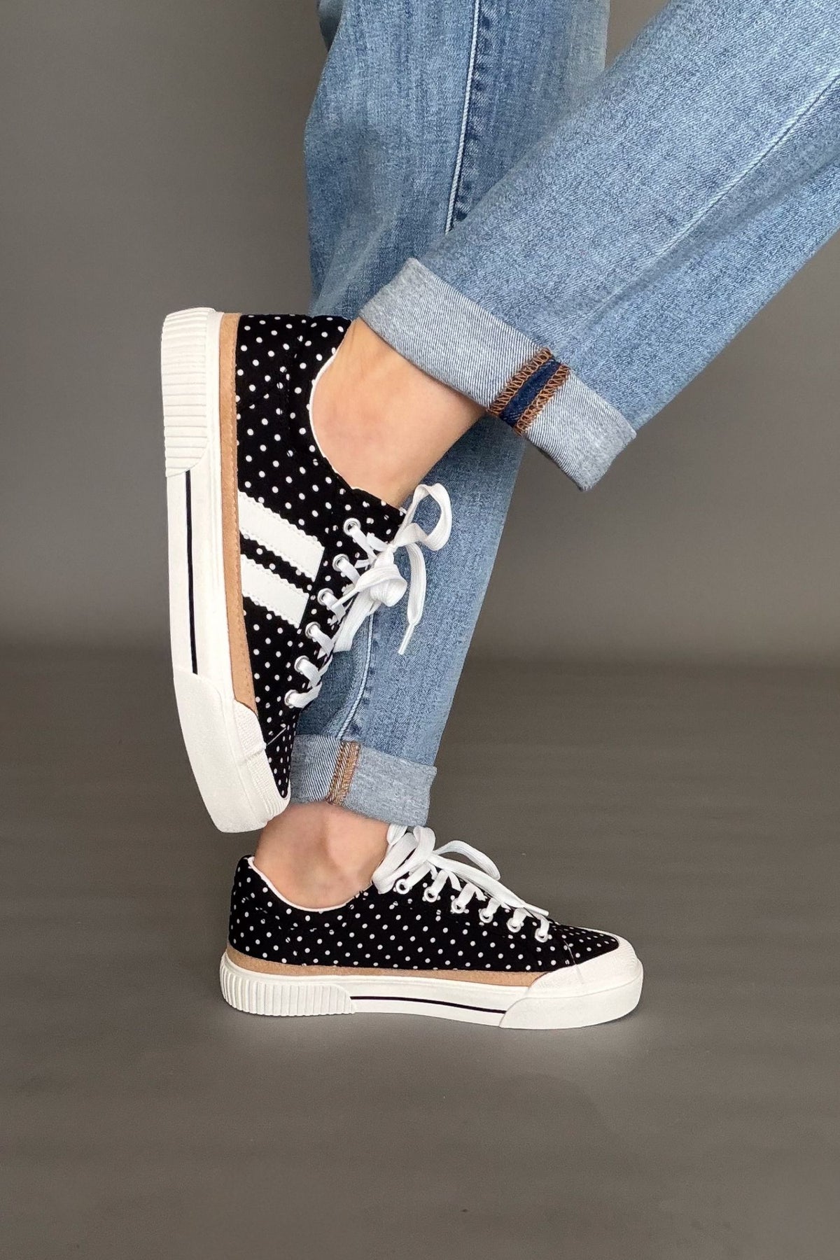 Corkys That’s Her black and white polka dot sneakers with white laces and tan stripe along the sole