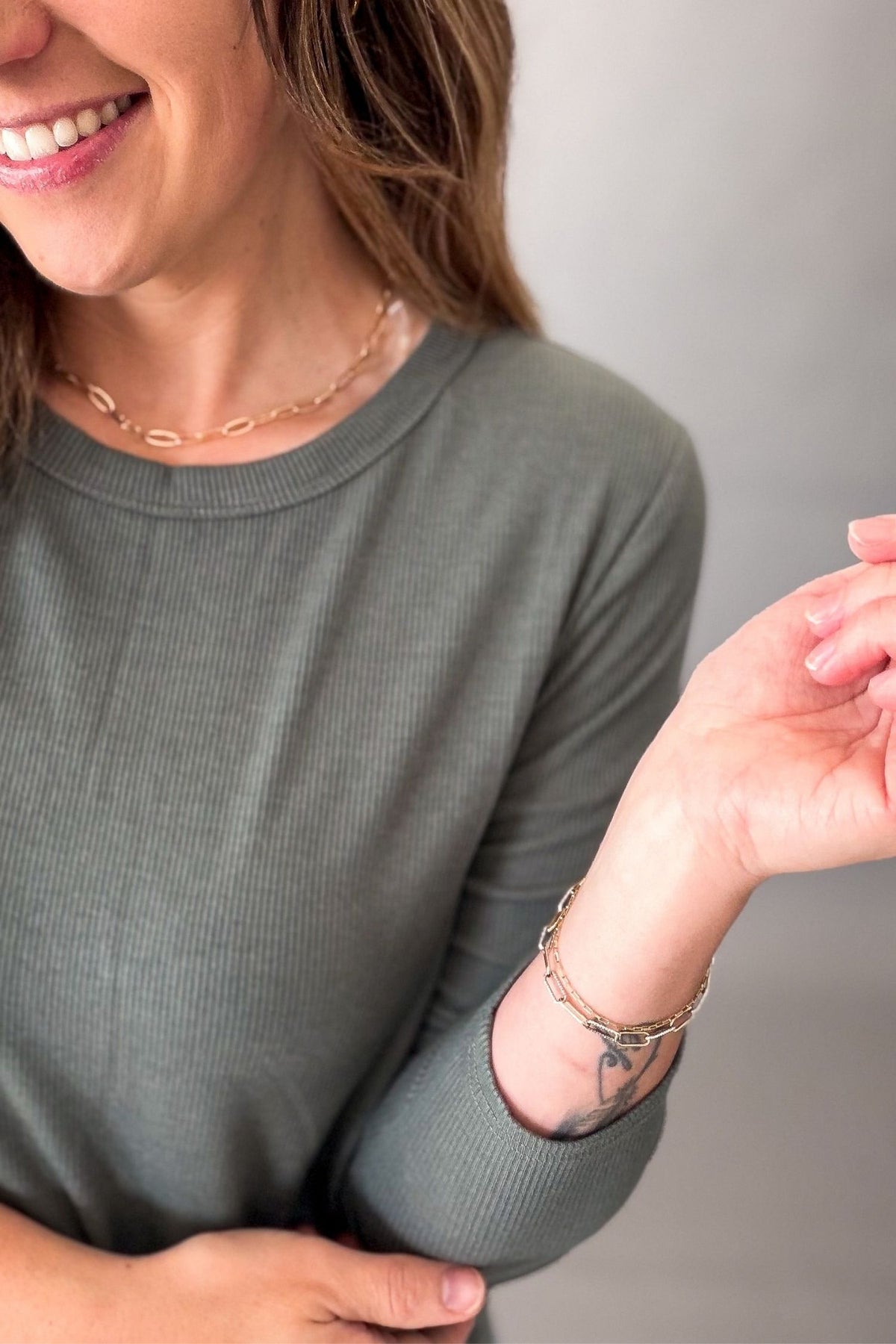 woman wearing a olive ribbed long sleeve showing upclose details 