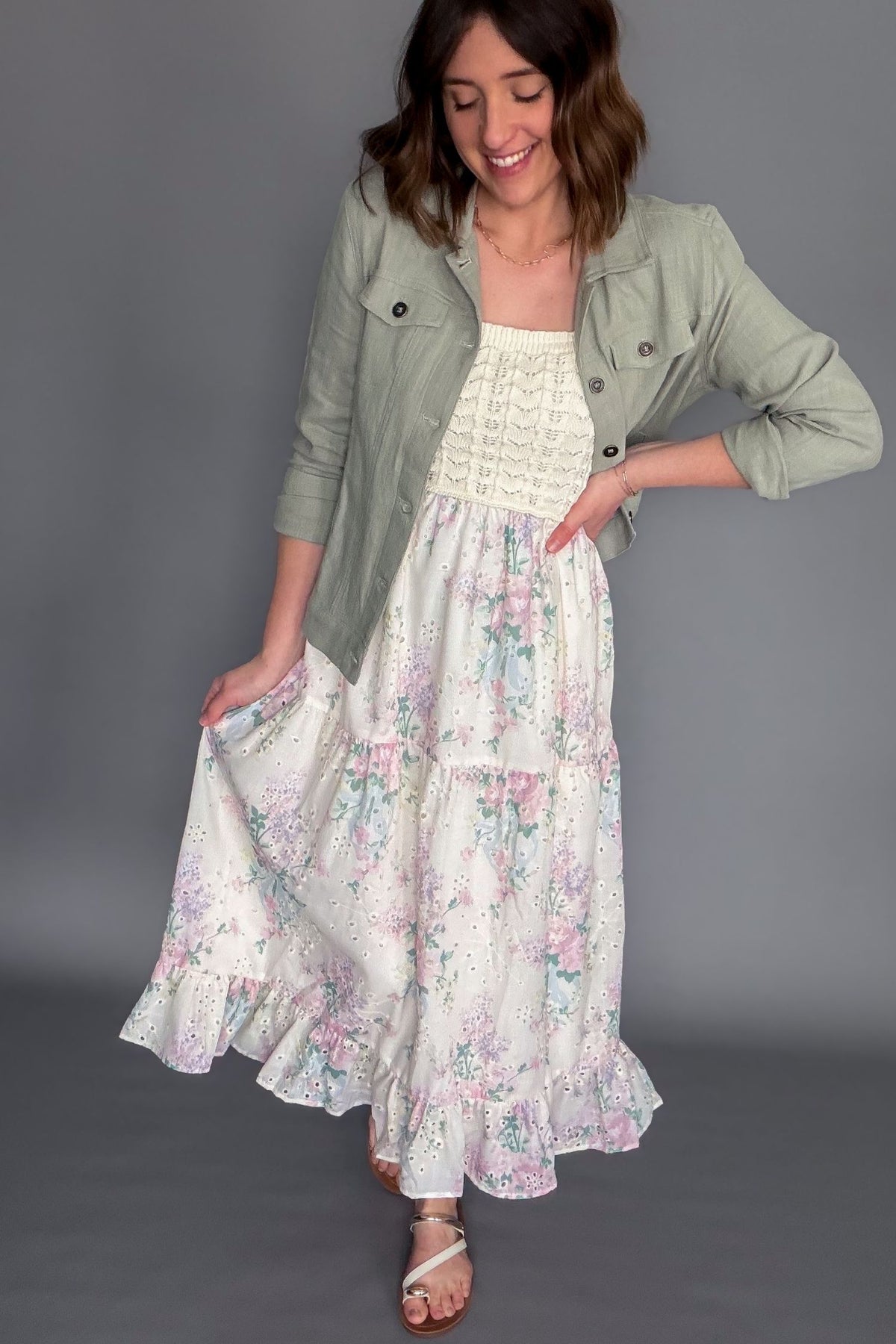 Crochet bodice floral midi dress with adjustable straps and tiered ruffle skirt paired with a linen cotton blend sage jacket.