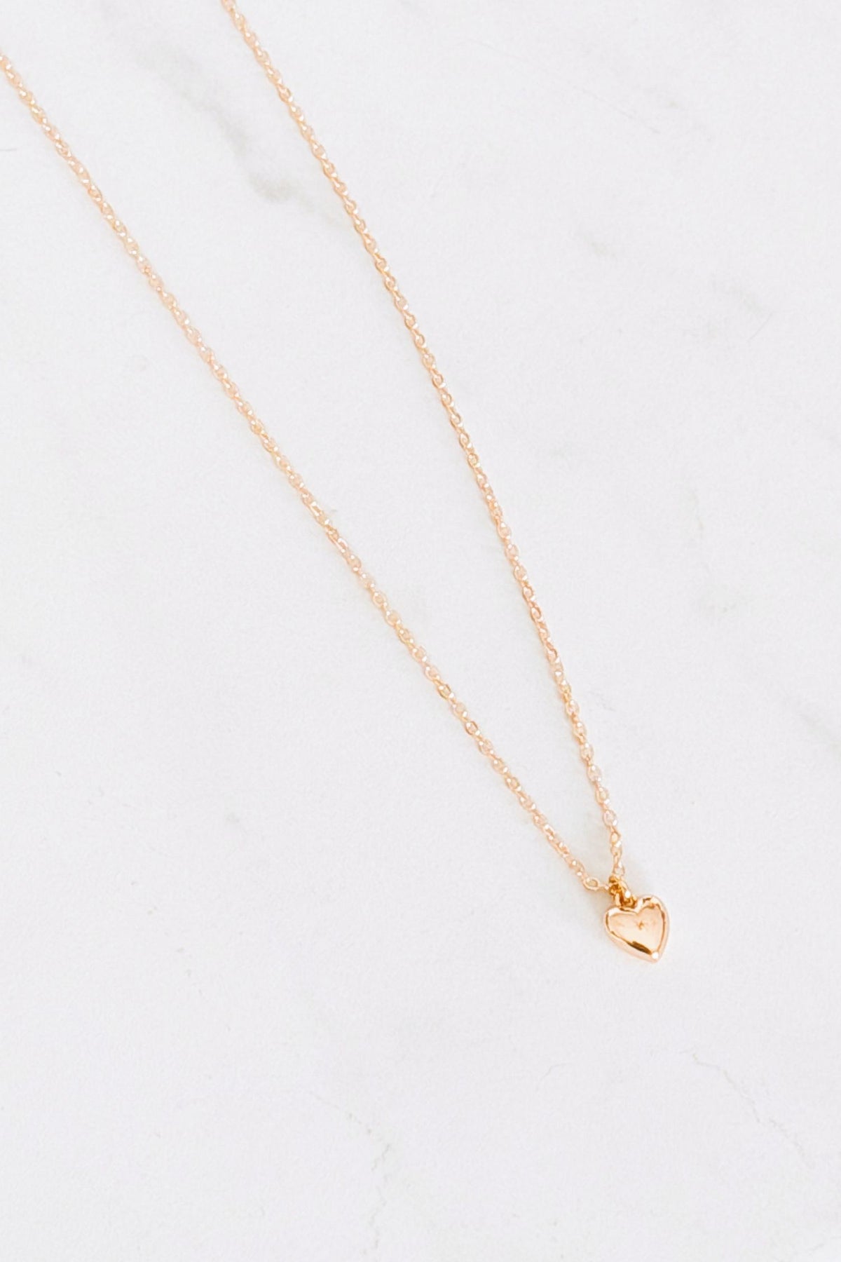 18 k Gold plated necklace with a heart pendant on a white background