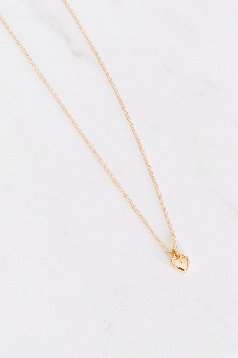 18 k Gold plated necklace with a heart pendant on a white background