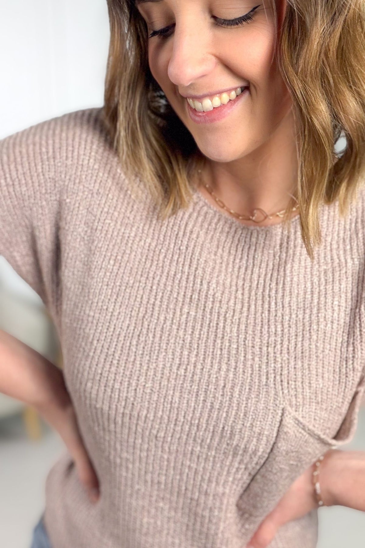 Dusty mauve short sleeve knit sweater with boxy fit and chest pocket showing close up details