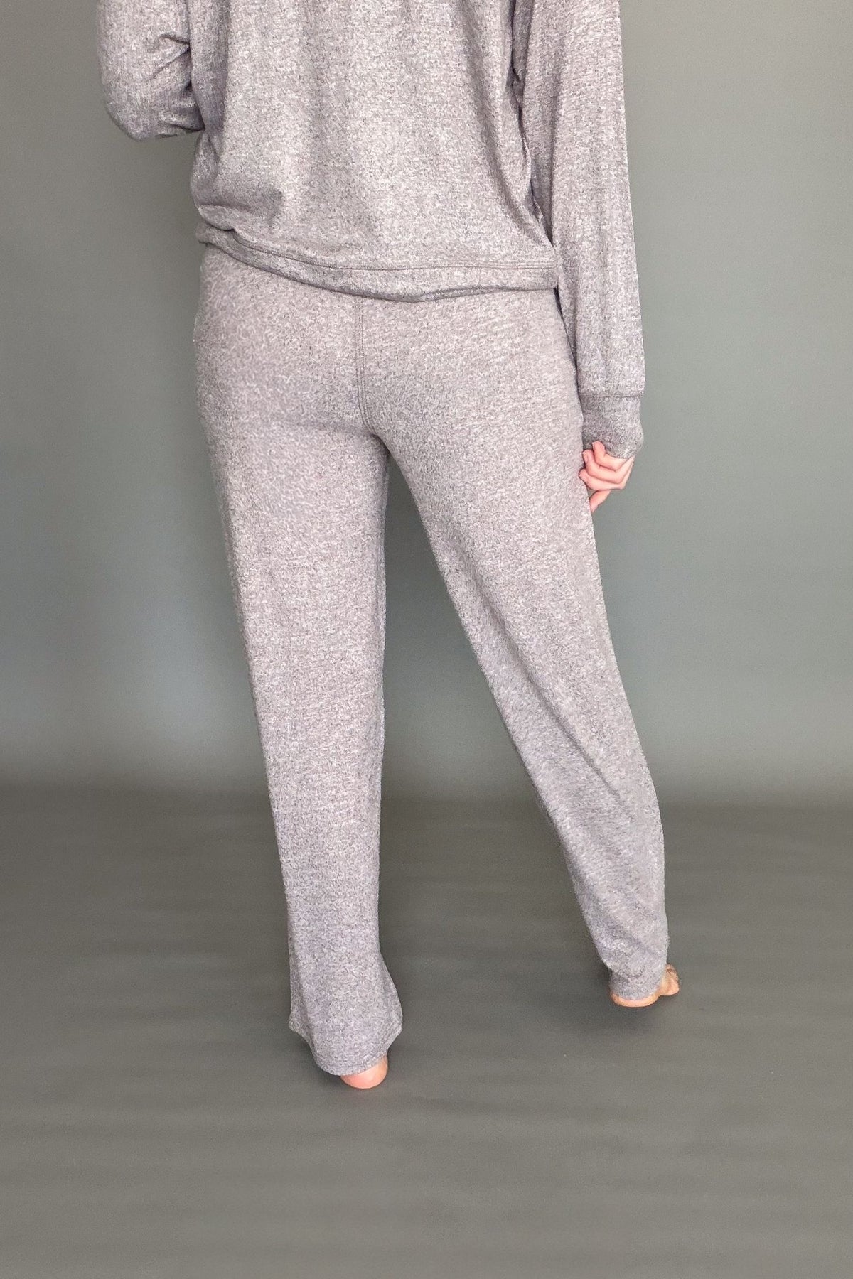 Women's espresso brushed lounge pants worn on a grey background showing the back