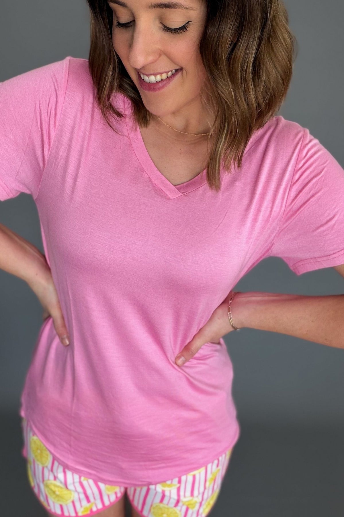 light pink lightweight v-neck tee styled with aqua drawstring shorts.