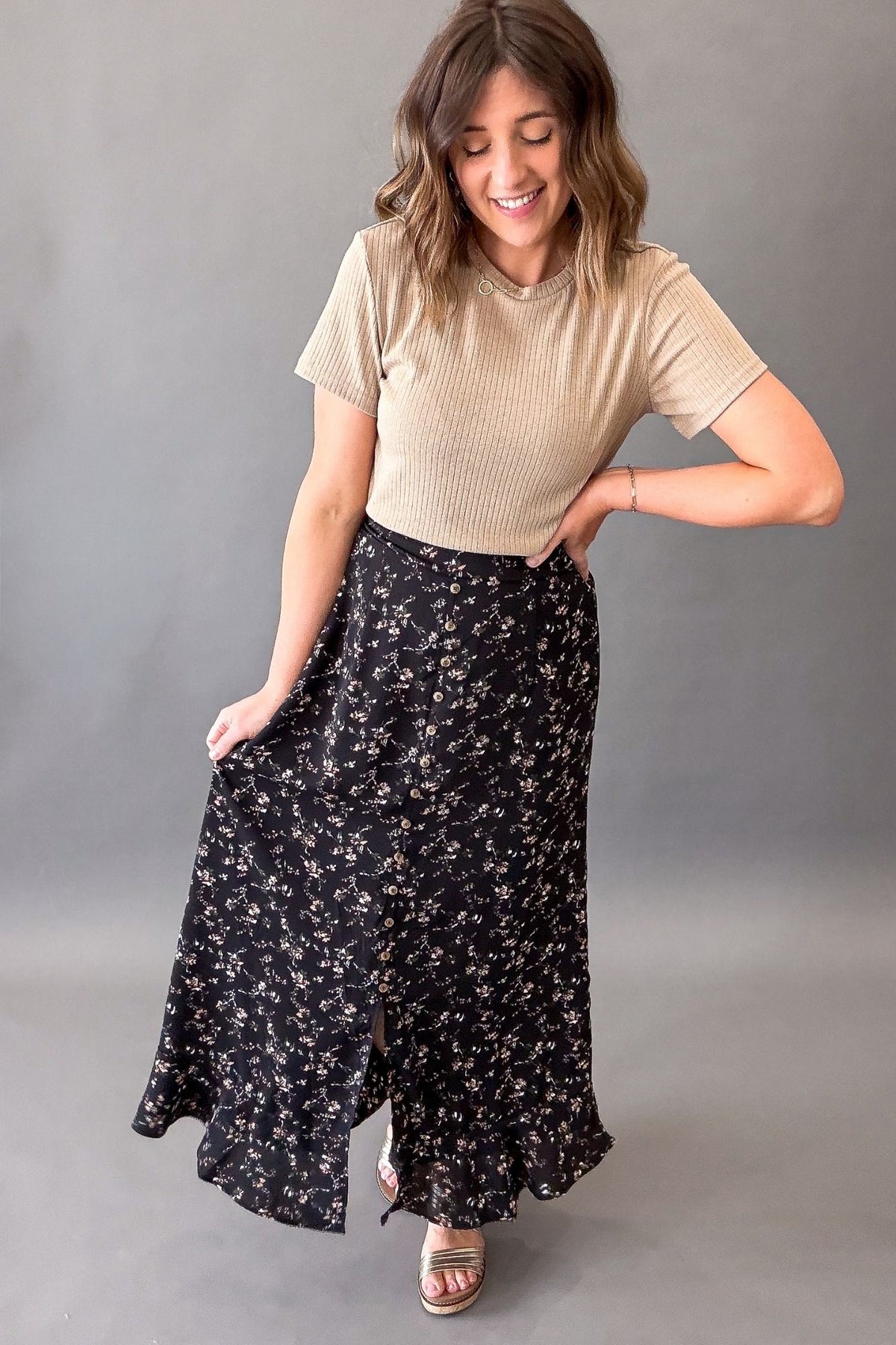 woman wearing a Casual feminine floral maxi skirt with a light neutral top