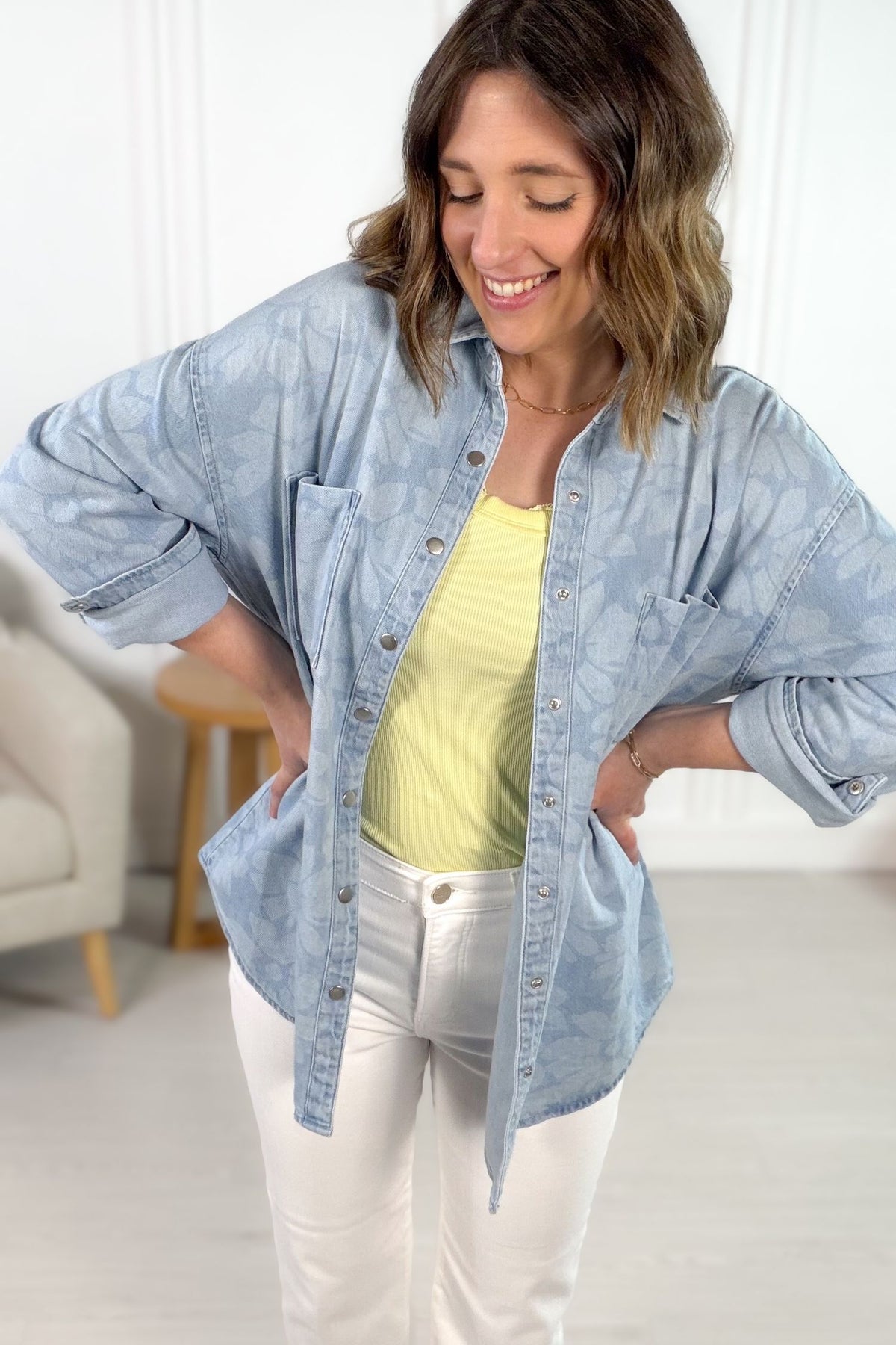 Floral print light denim button up layered over a yellow tank and white pants
