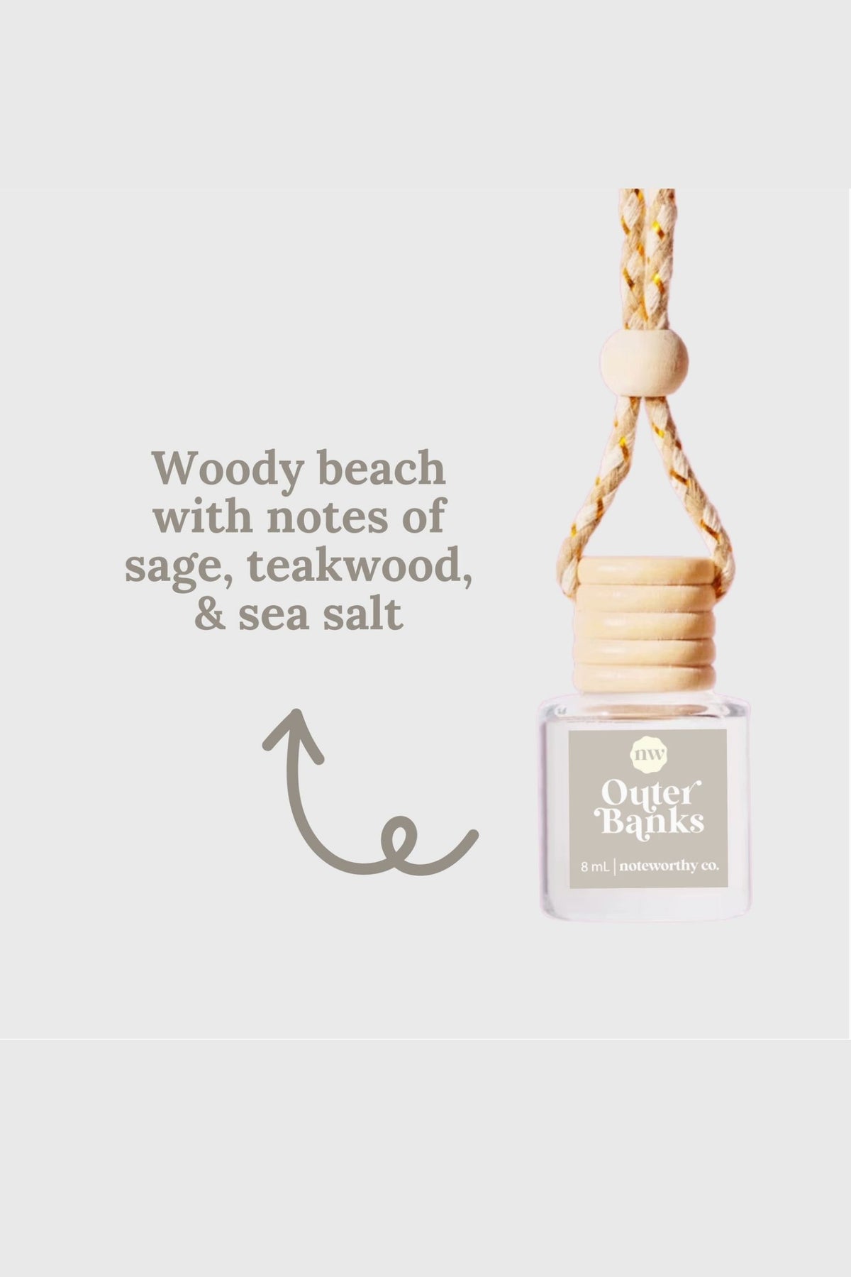 hanging car diffuser glass bottle with wooden bead on a light gray background