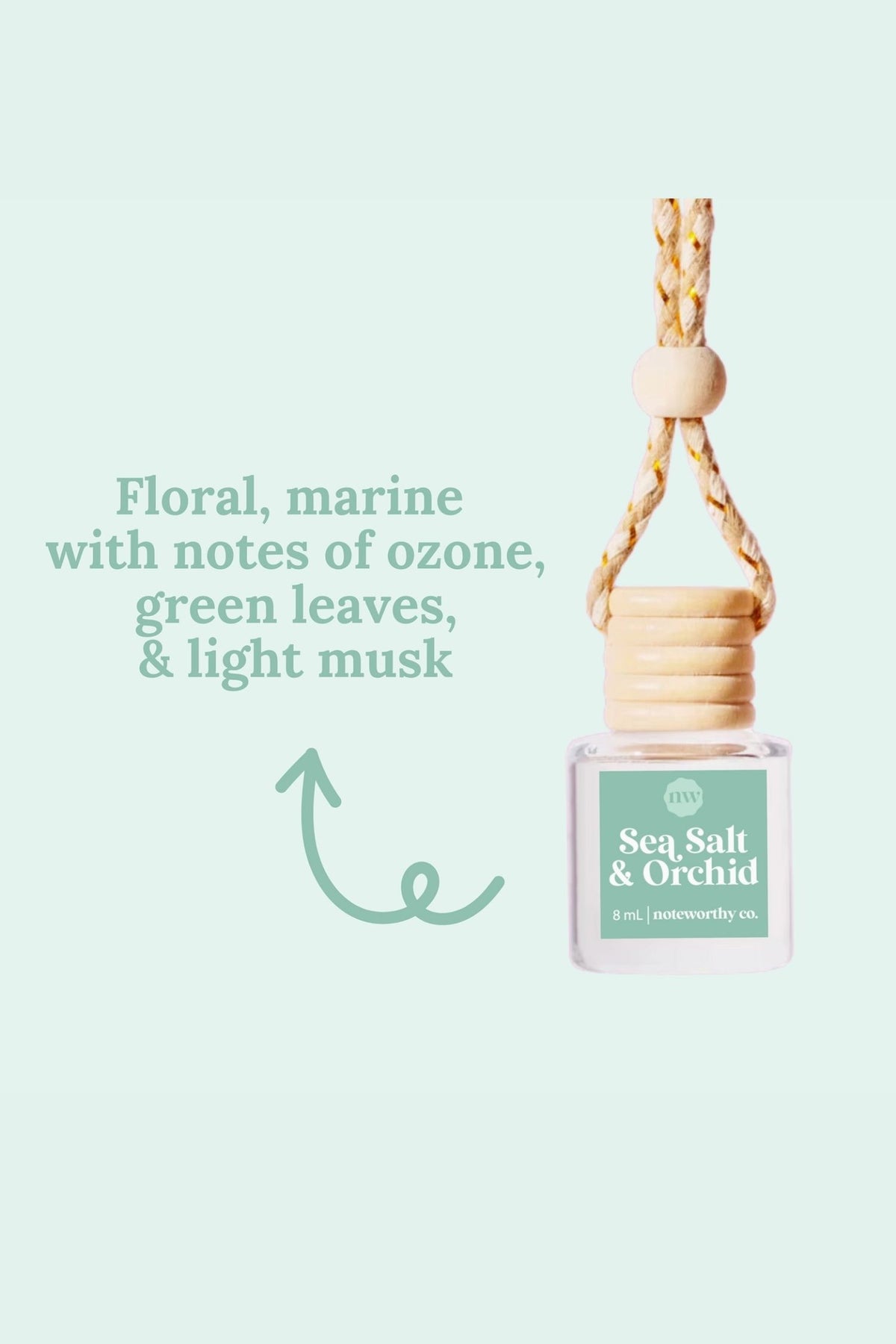hanging car diffuser bottle labeled 'Sea Salt & Orchid' with a light green background and text about fragrance notes.