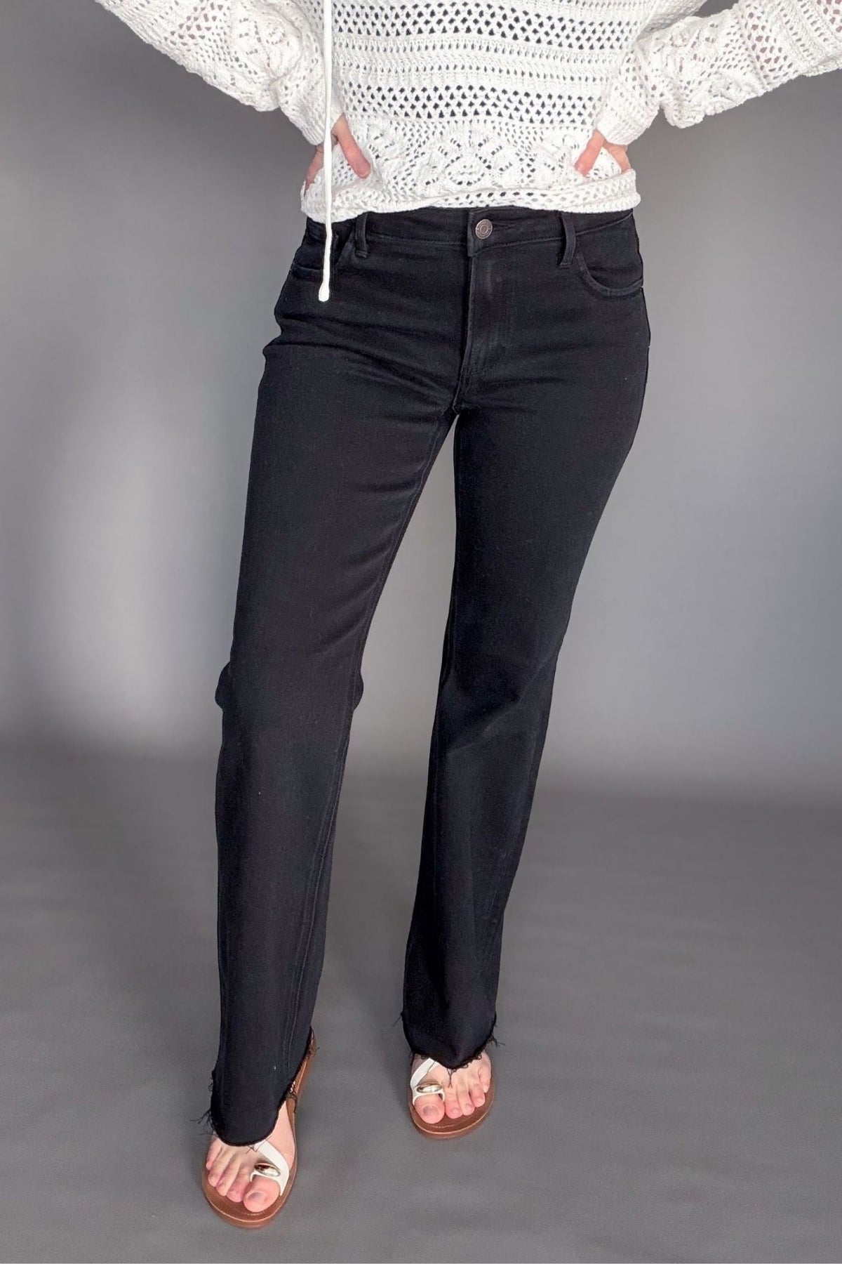 High rise black bootcut jeans styled with a sweater and sandals