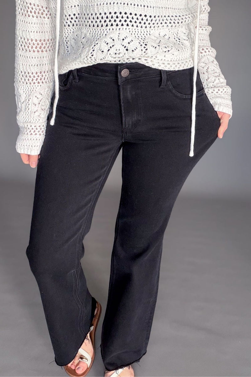 High rise black bootcut jeans styled with a sweater and sandals