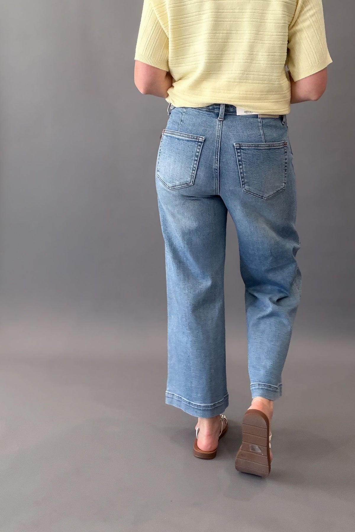 woman wearing judy blue ankle jeans showing the back pockets