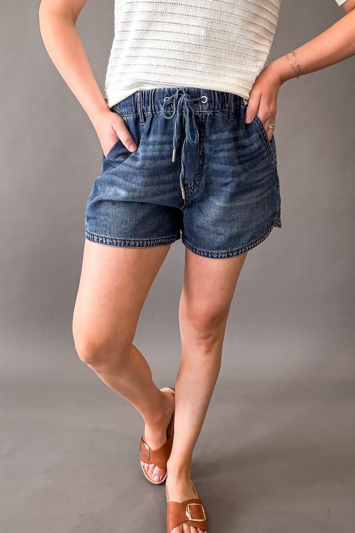 Woman wearing Judy Blue high waist boxer shorts with drawstring waist and pockets, lightweight soft denim shorts for women