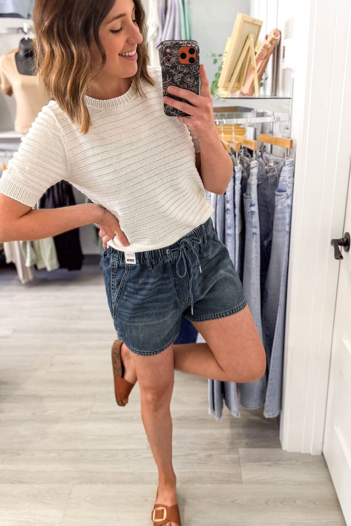 Woman taking a selfie wearing Judy Blue high waist boxer shorts with drawstring waist and pockets, lightweight soft denim shorts for women
