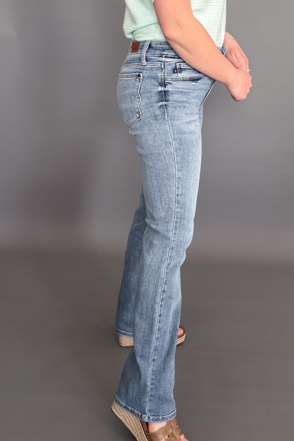 Judy Blue mid rise bootcut jeans with soft stretchy denim and flattering fit showing side details