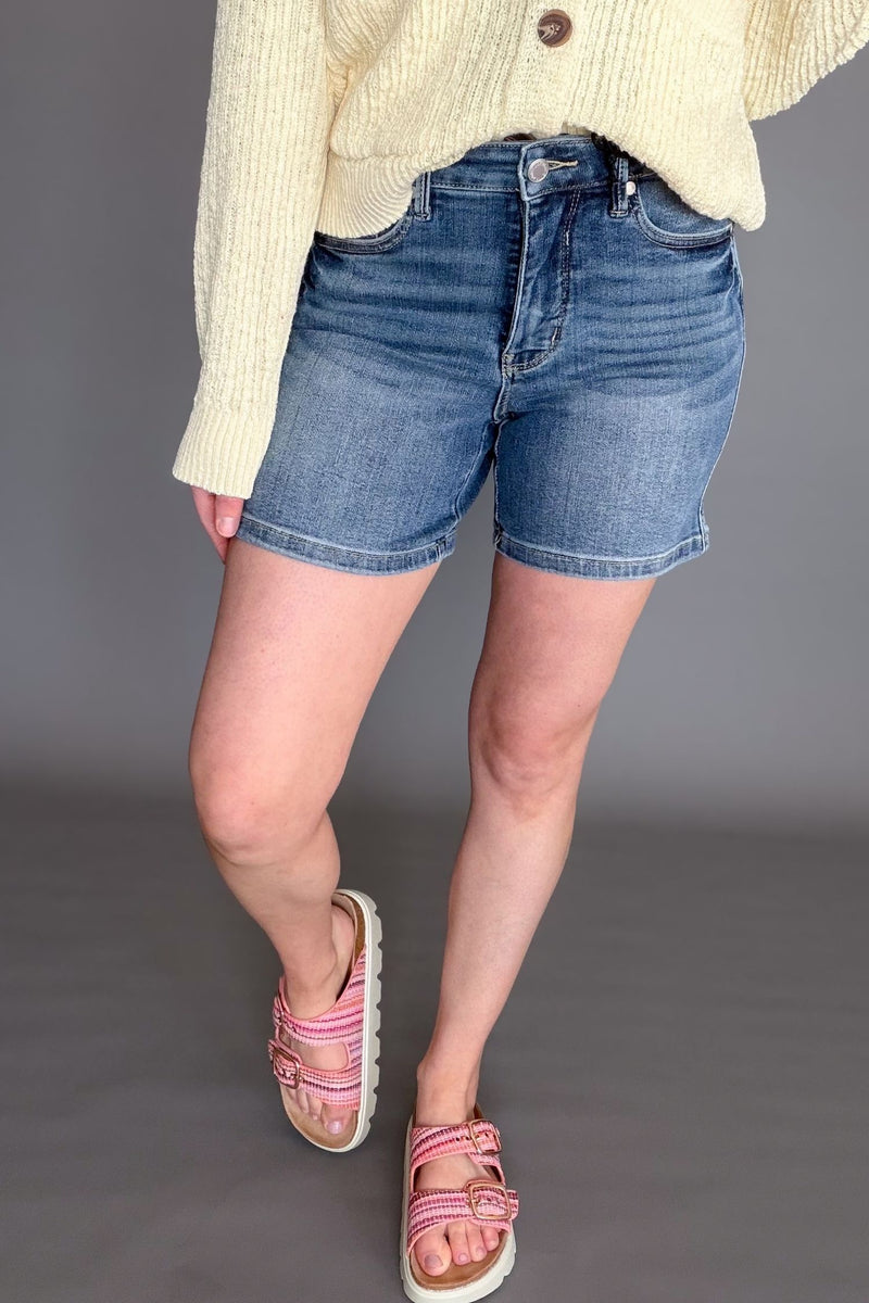 Judy Blue mid rise tummy control mid length denim shorts on model front view