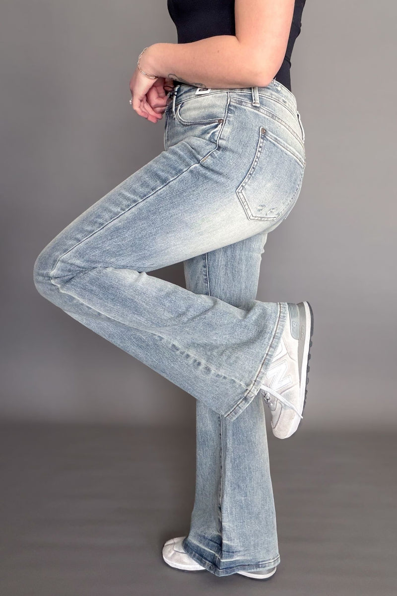 Light blue jeans worn by a person on a gray background