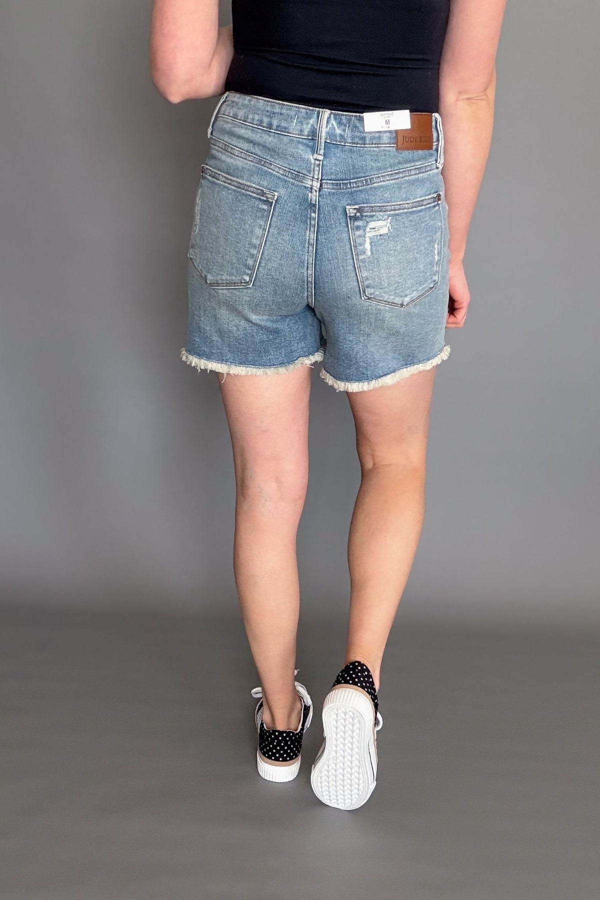 Women’s Judy Blue Tinley high rise distressed jean shorts outfit showing back of denim shorts