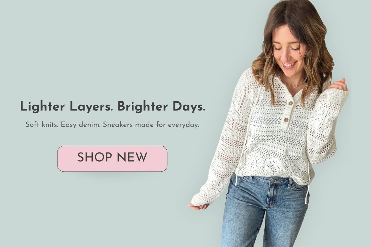 Woman wearing a white knit top and blue jeans with promotional text on a light green background with a shop new button