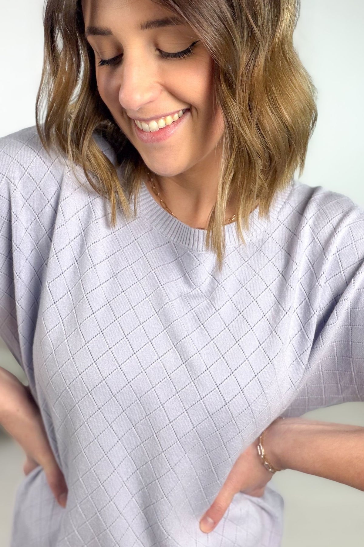 Lavender pointelle short sleeve knit top with diamond texture showing close up details