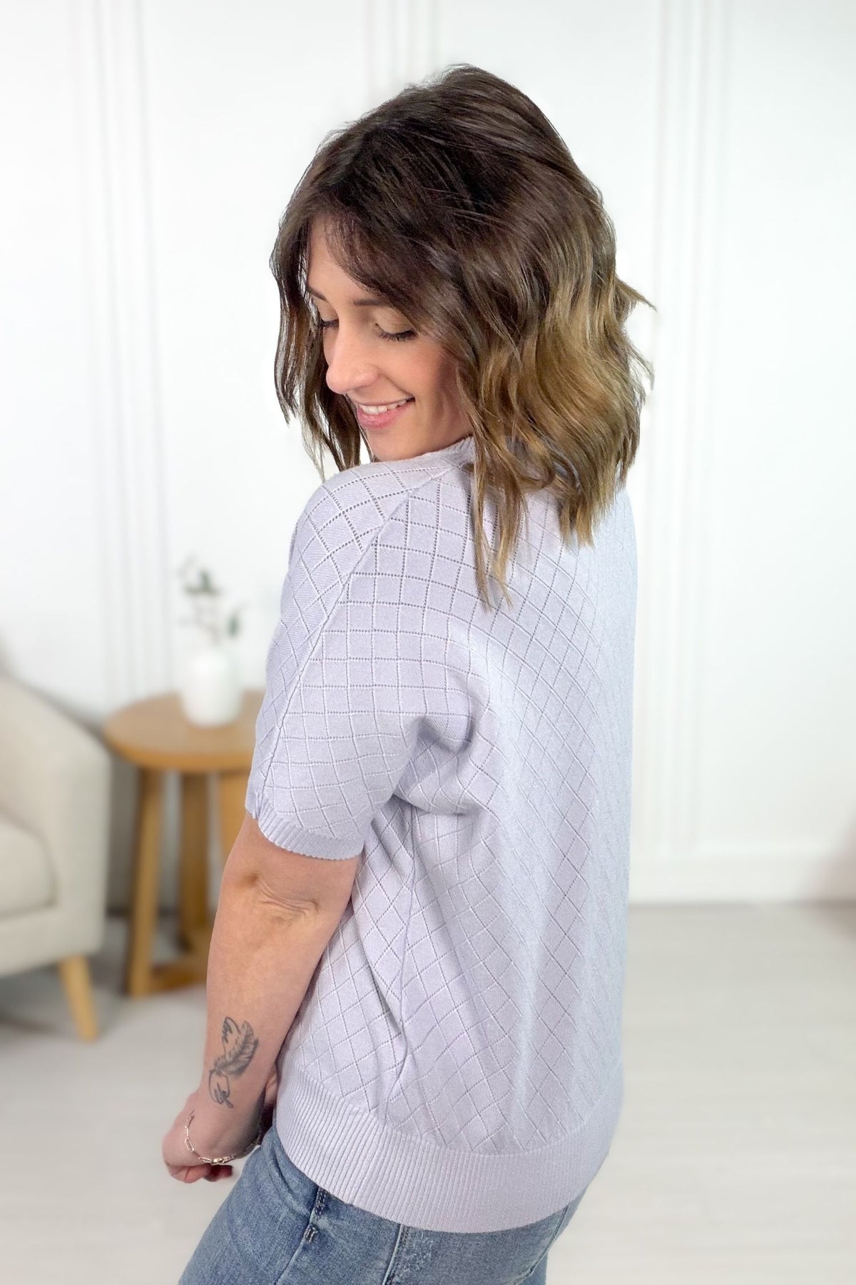 Lavender pointelle short sleeve knit top with diamond texture showing back details