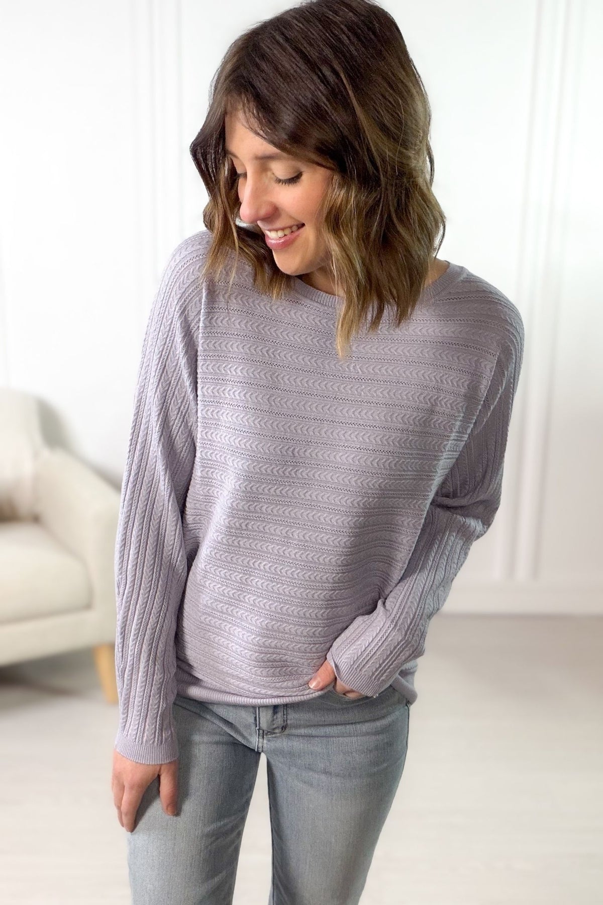 Women's lilac braided pointelle sweater with textured knit styled with light wash denim.