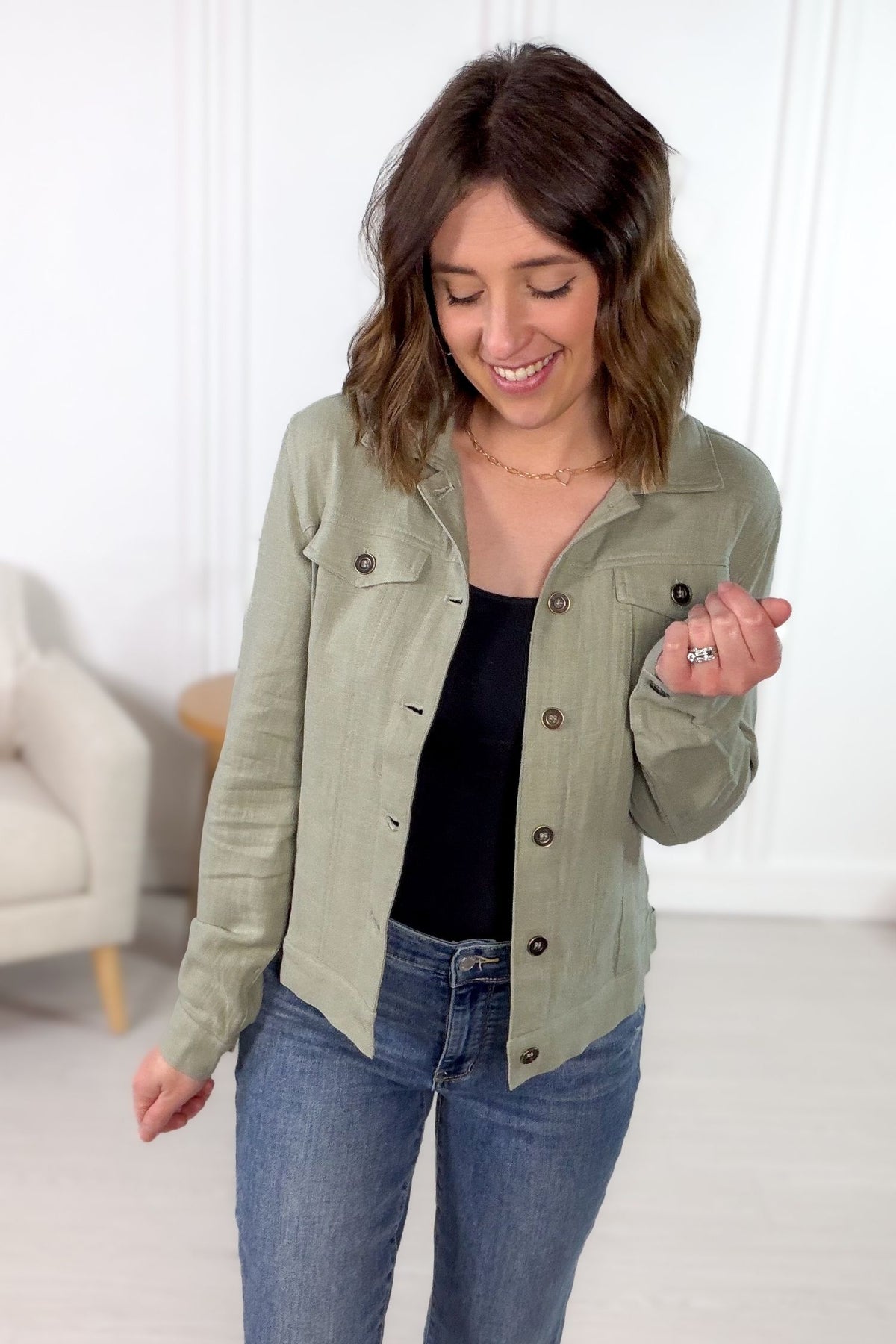 Sage linen blend lightweight jacket with metal buttons styled with denim