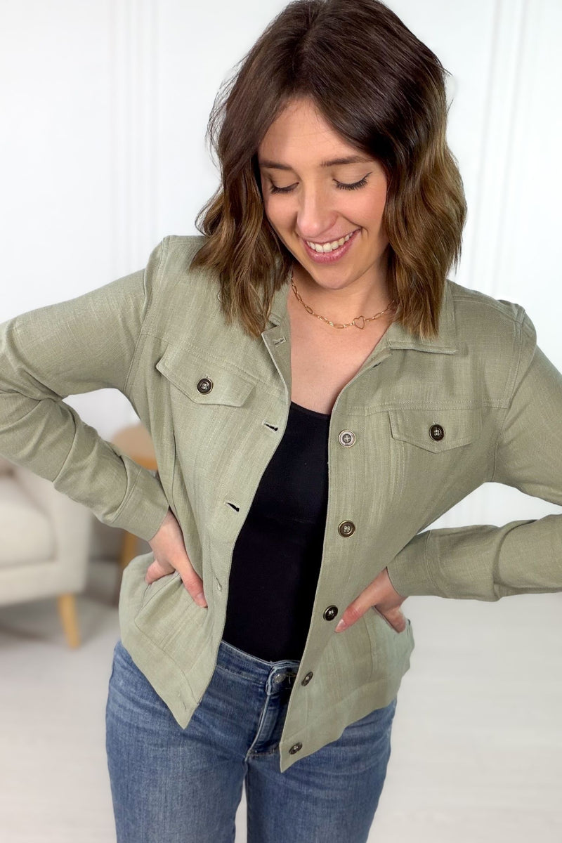 Sage linen blend lightweight jacket with metal buttons styled with denim