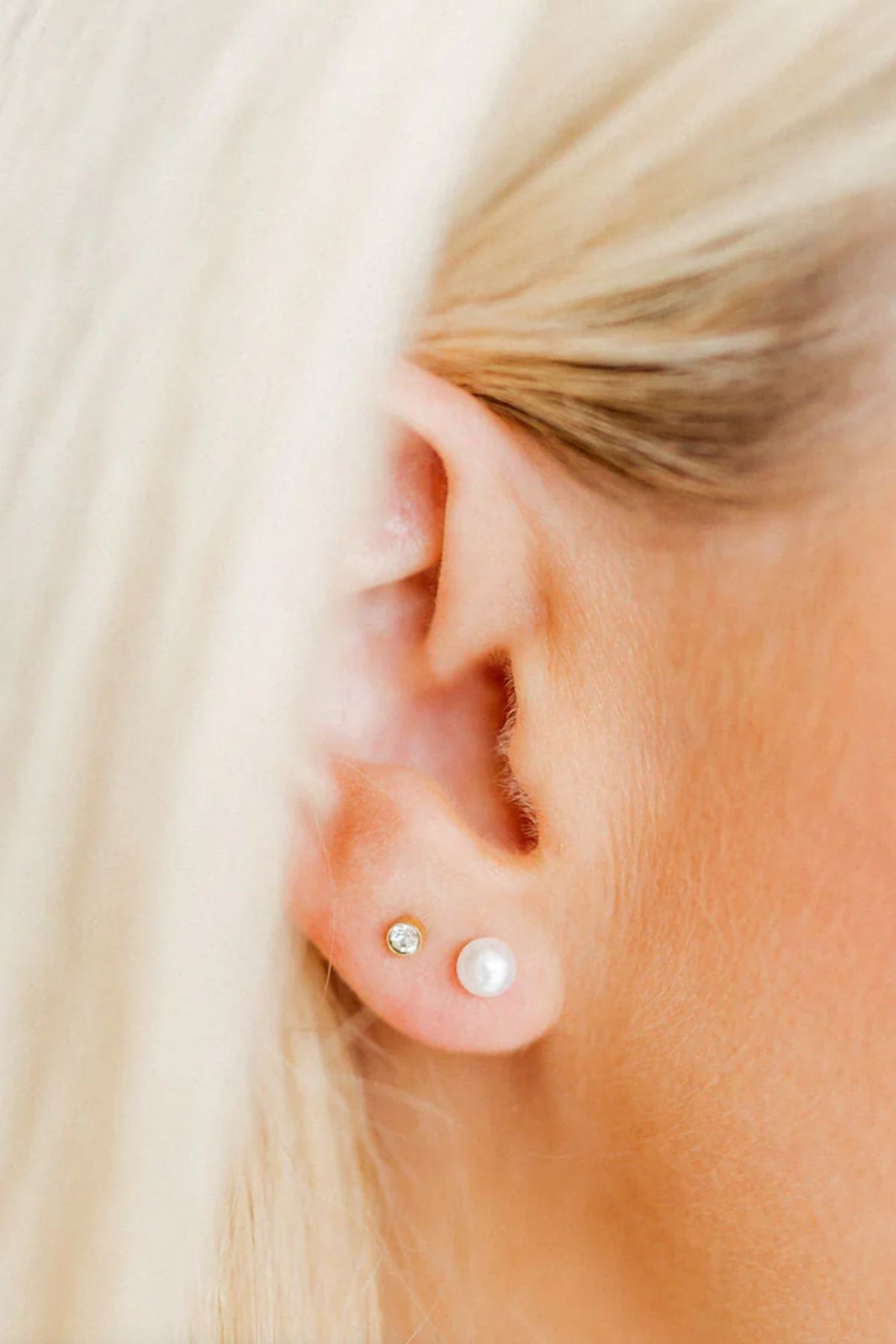 woman wearing a pearl earrings stud 