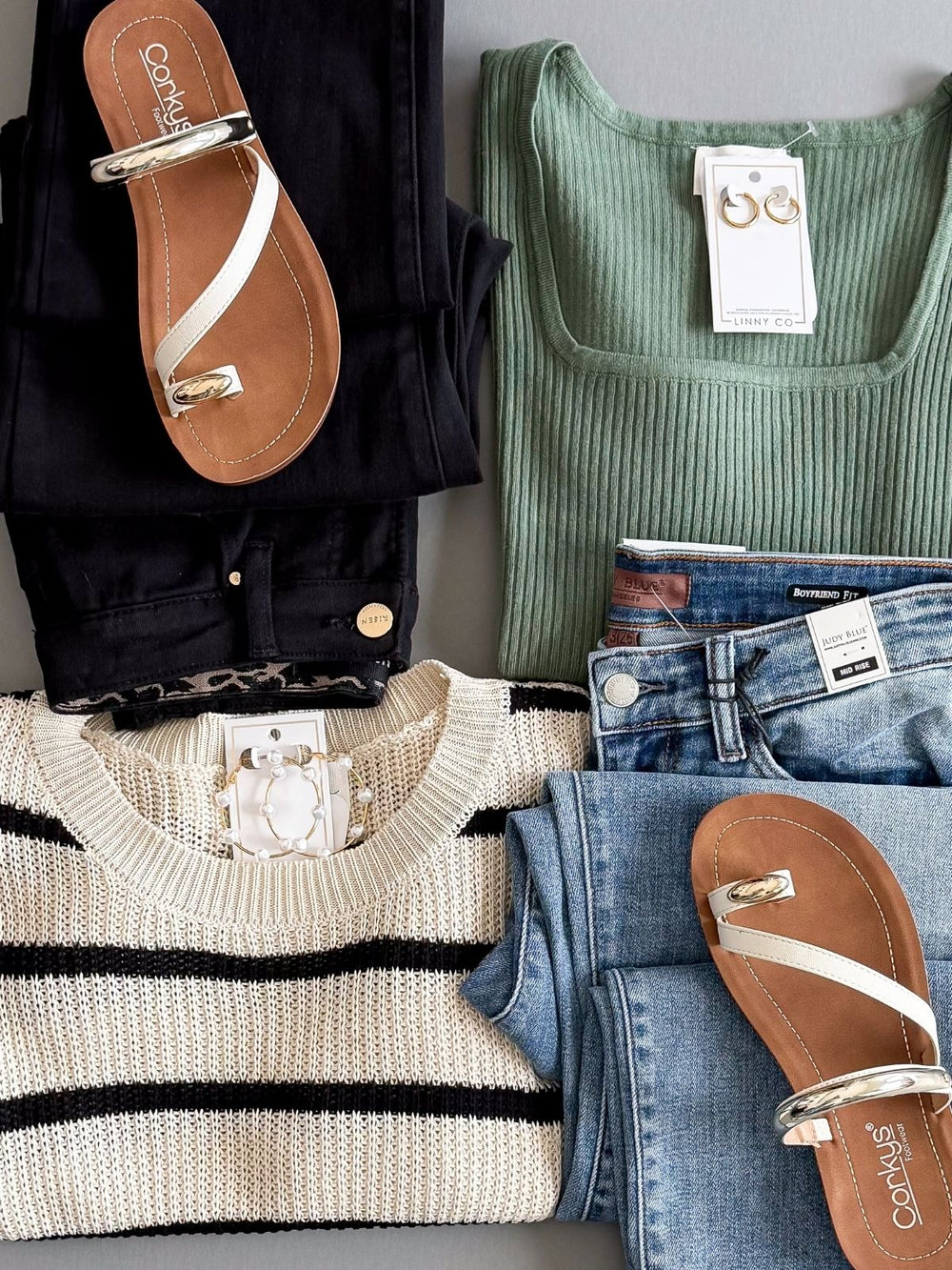 Flatlay of womens clothing including brands Corkys, and Judy Blue.