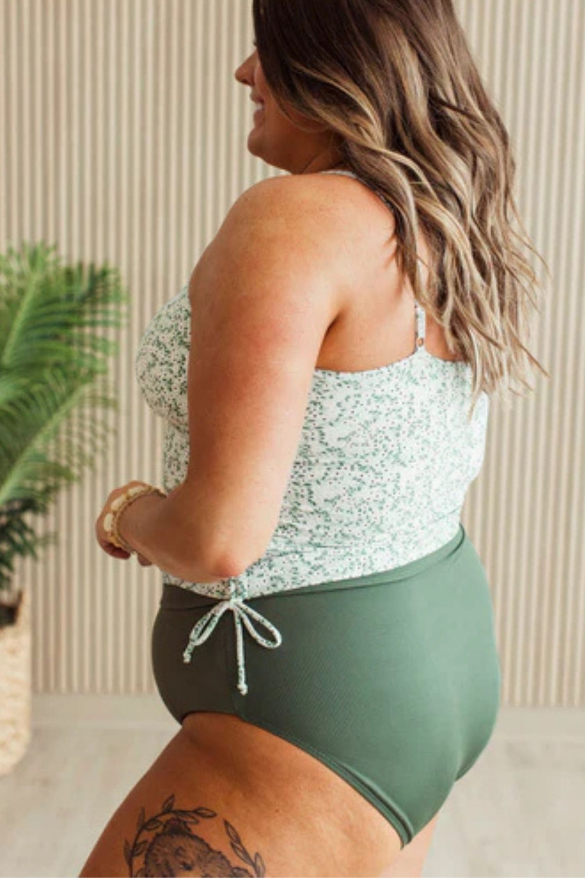 Mint floral ruched tankini swim top with adjustable sides and straps. showing side view